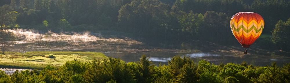 Fog and balloon over Quechee River.