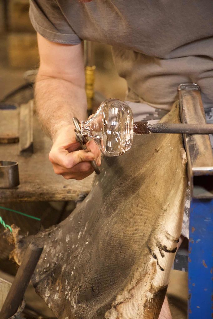 Glassworker snips off the rough edges