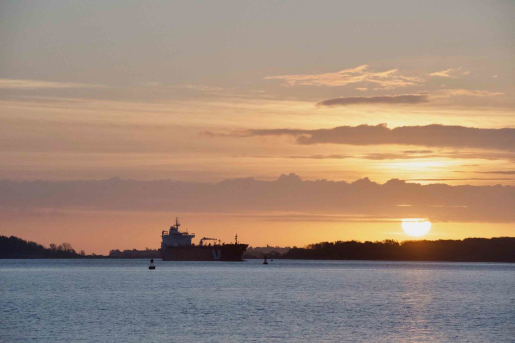 Tanker and sun rising behind Long Island