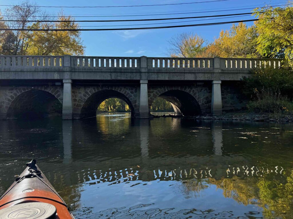 Downstream side of Route 109 bridge, showing original stonework and later concrete piers