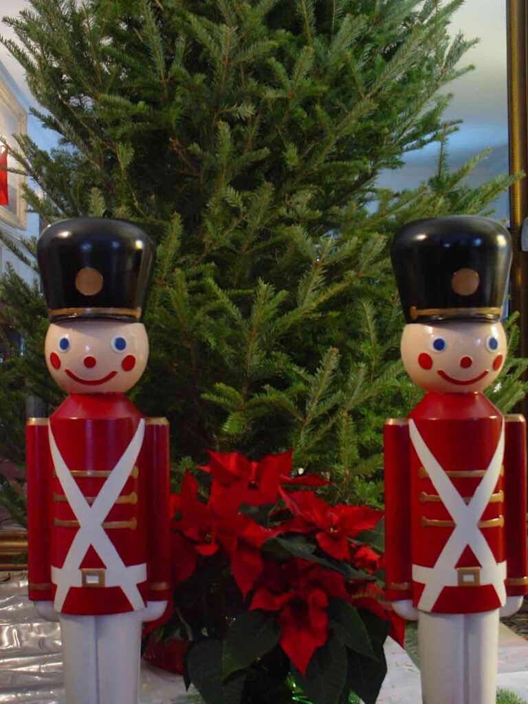 Two toy soldiers in front of bare tree