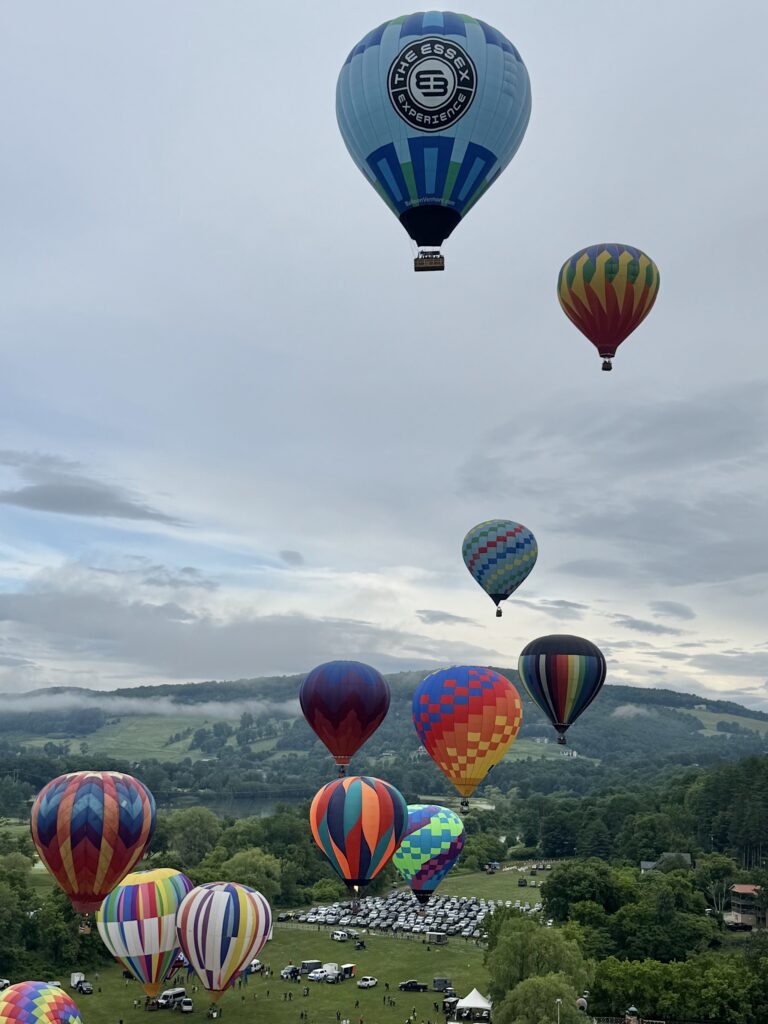 Balloons rising over the festival grounds